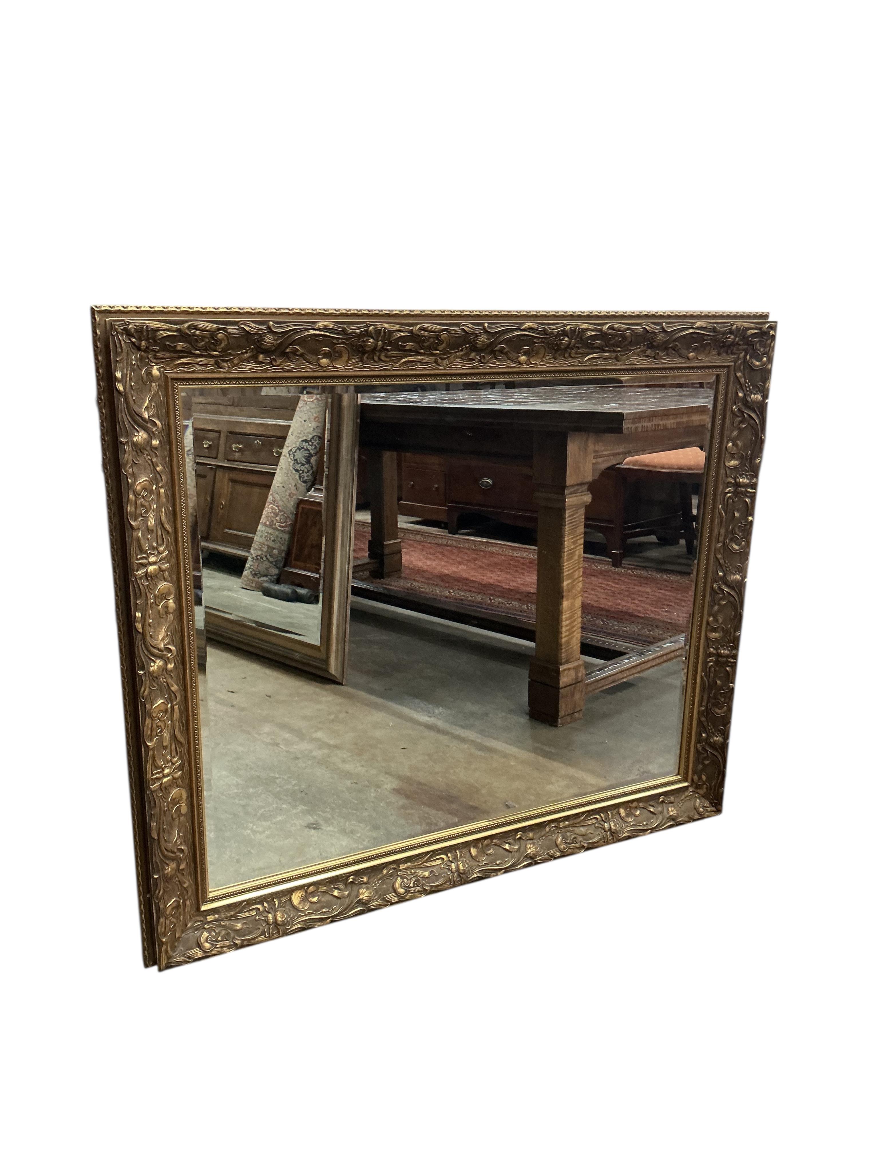 A reproduction Art Nouveau style gilt composition wall mirror, width 110cm, height 94cm